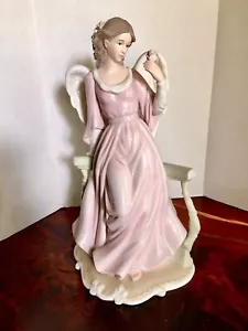 Beautiful porcelain figurine Angel holding flowers on garden balcony - Picture 1 of 10