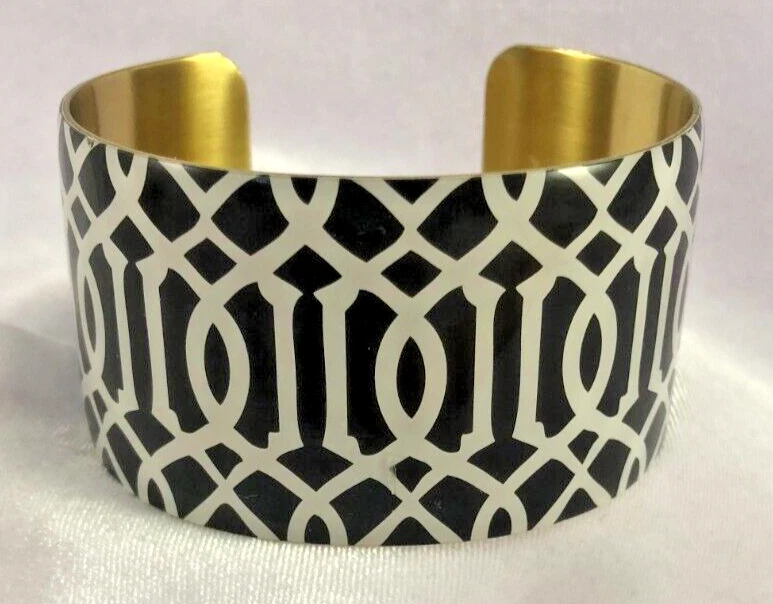 Brazalete ancho tono dorado diseño geométrico blanco y negro MUD PIE Foto 1 de 4