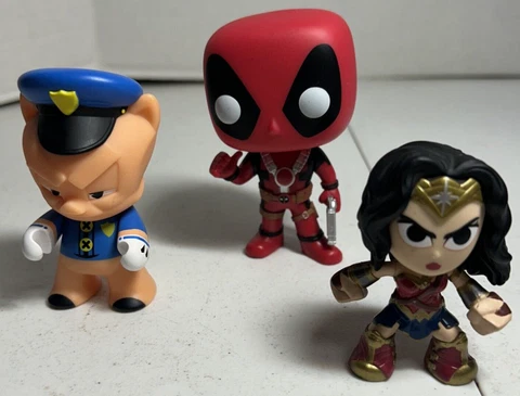 Lot of Three Vinyl Figures including Pop Deadpool ,Wonder Women and Porky Pig Cover