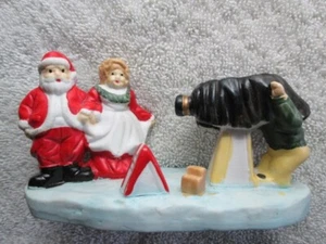 Santa And Mrs. Claus Having Their Picture Taken Ceramic Figurine - Picture 1 of 4