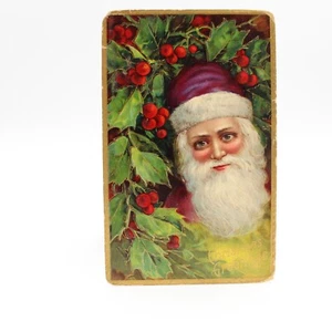 Tarjeta postal de felicitación de Navidad con acebo de Santa túnica púrpura c.1910 - Imagen 1 de 2