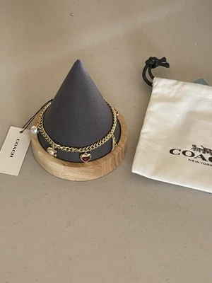 PULSERA COACH TONO ORO CADENA FIRMA MULTI DIJES 8” Foto 1 de 4