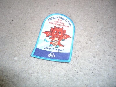 BRAND NEW GIRLGUIDING CYMRU ICE HOCKEY EXTRAVAGANZA GIVE IT A GO CLOTH BADGE - Image 1 of 4