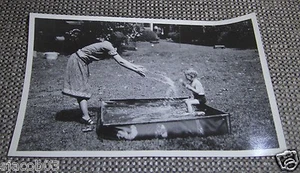 1940's 5.5" by 3.5" Photo Of Mother Splashing Water On Infant In Backyard Pool - Picture 1 of 2