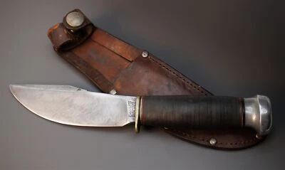 Cuchillo desollador de caza de cuero apilado artesanal en madera de principios de 1920 canicas EE. UU.  Foto 1 de 4
