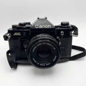Canon A-1 35mm SLR Film Camera Black w/ 50mm f/1.8 Lens & Flash - Picture 1 of 3