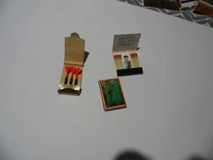 3 x 70s/80s novelty matchbook/boxes mini gold plated darts,rude man,can-can girl - Picture 1 of 10
