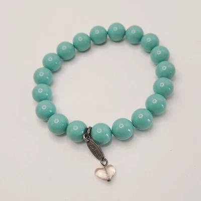 Pulsera elástica Sabika tono turquesa con cuentas de vidrio Foto 1 de 4
