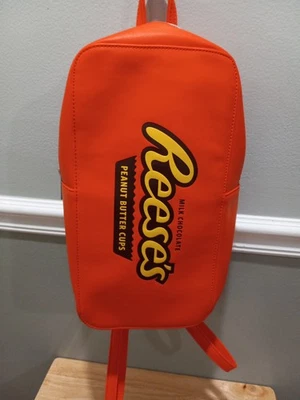 MOCHILA CON LOGOTIPO TAZAS DE MANTEQUILLA DE MANÍ CHOCOLATE CON LECHE REESE'S NARANJA SÓLIDO USADA LEER Foto 1 de 4