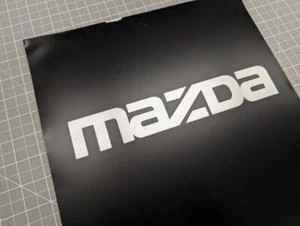 2 pack - Mazzda logo Gloss Silver metallic vinyl Decal Sticker 15.5" wide x 2.5" - Picture 1 of 9