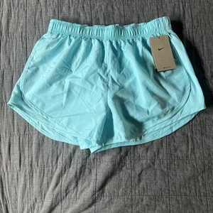 Nike Damen Dri-Fit kurze gefütterte Laufshorts CU8890-491 blau Größe M neu mit Etikett - Bild 1 von 7