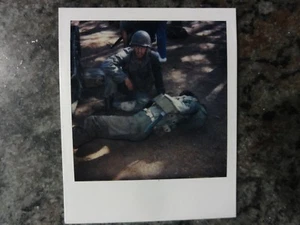 Polaroid Photo of 2 GI Soldiers Laying on Ground With Knife Shown - Picture 1 of 1