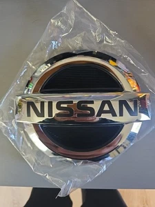 NEW OEM Nissan 2016-2023 TITAN Radiator Grille Emblem Front Logo 62382-EZ00A - Picture 1 of 5