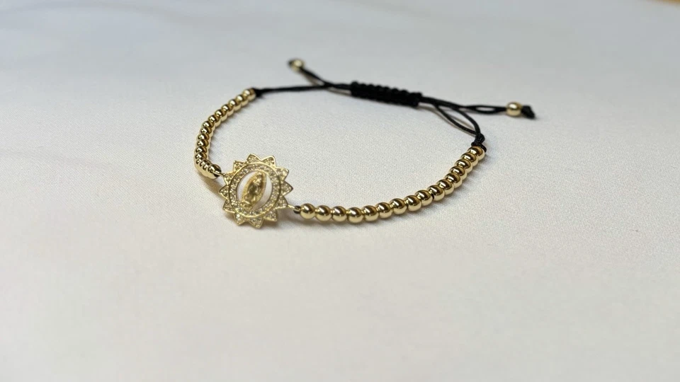 Pulsera unisex oro laminado 18k con dije religioso floral elegante Foto 1 de 4