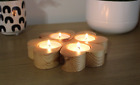 Wooden candle holder for four tea lights.  Four hearts fold into a clover.