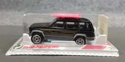 Jeep Cherokee Limited w/ Surfboards - Majorette 1:64 - Black - Image 1 of 4