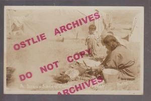 Gordon NEBRASKA RPPC c1920 SIOUX INDIAN CAMP Woman COOKING DOG Describes TASTE!! - Picture 1 of 3