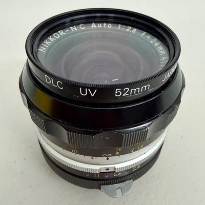 Lente principal gran angular Nikon NIKKOR-NC automática 24 mm f/2,8 Pre-AI - Nikon F - Japón Foto 1 de 4