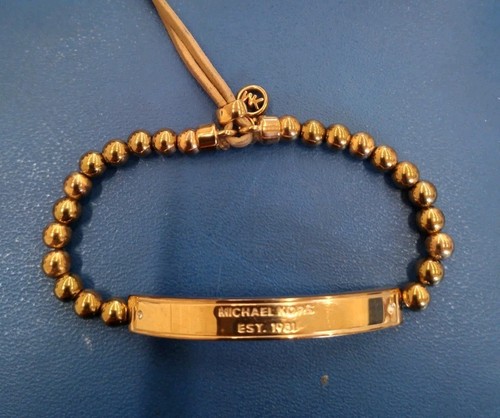 Bracciale Michael Kors perle tono oro rosa con barra incisa e cordino regolabile