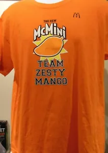 McDonald McMINI Team Zesty Mango BRAND NEW T Shirt L Staff Employee Logo - Foto 1 di 4
