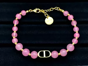 Christian Dior Ladies Pink and Gold Beaded Adjustable Bracelet - Picture 1 of 2