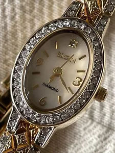 Reloj para dama Elgin tono dorado y piedras preciosas transparentes EG9857 - Imagen 1 de 13