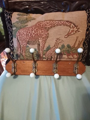 Brass and ceramic wall,jacket,or hat hooks on wood base,4 hooks. - Image 1 of 4