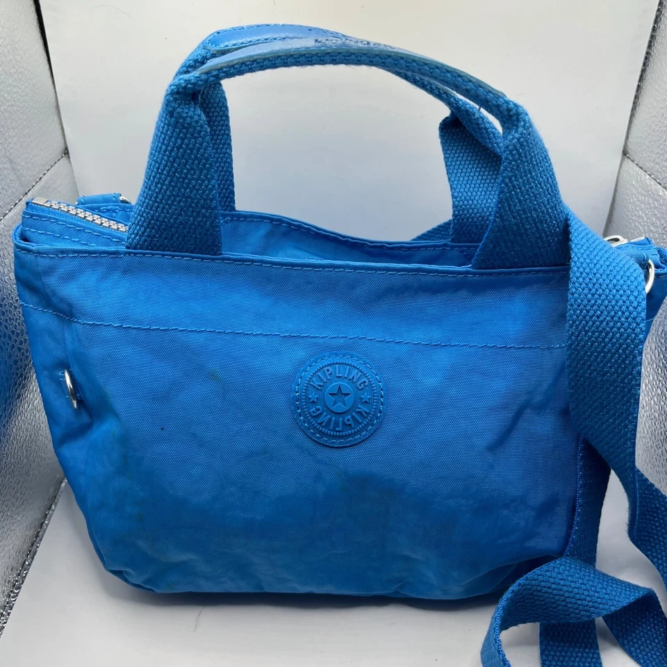 Mini bolso de mano Kipling azul de nailon bandolera correa ajustable Foto 1 de 4