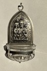 Holy water font with pressed motif of Saint Joseph holding InfantJesus