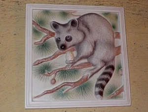 RACCOON art tile. CRAFTY RACCOON PERCHED IN TREE HOLDING A SPOTTED EGG. 6 3/8 " - Picture 1 of 3