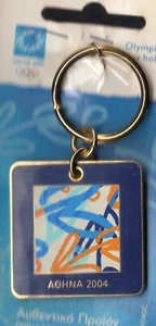 ATHENS 2004. OLYMPIC GAMES KEYCHAIN. SQUARE. BLUE AND ORANGE MOTIFS OF THE GAMES - Picture 1 of 2