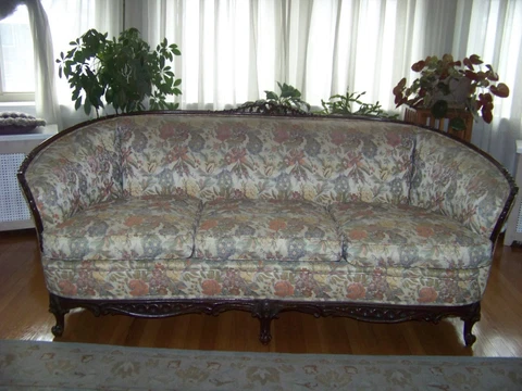 Beautiful Antique Sofa and Chair Accented in Wood Cover