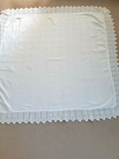 Vintage white table cloth with embossed flower pattern centre.