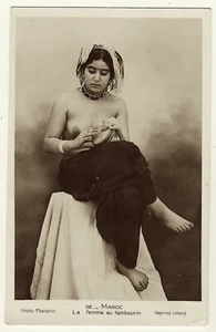 A TOPLESS TATOOED WOMAN AND HER TAMBOURINE IN MOROCCO - Picture 1 of 3
