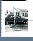 FOUND B&W PHOTO N_0661 MAN POSED ON SIDE OF OLD CAR