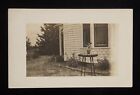 RPPC 1910s Cute Terrier Dog on a Tall Table in the Yard Unknown Location