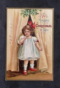 Postal de Navidad de Ellen Clapsaddle niña lazo rojo en el pelo ~ debajo del muérdago - Imagen 1 de 2