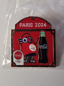 PARIS 2024 OLYMPIADE COCA-COLA MASKOTTCHEN SPONSOR ANSTECKNADEL - Bild 1 von 1