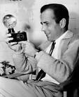 Humphrey Bogart holding a camera on the set of the film 'They D - 1940 Old Photo