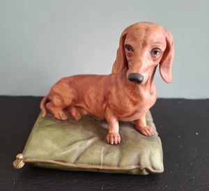 A late 20th century CAPODIMONTE sitting Daschund or Sausage dog on a cushion. - Picture 1 of 8