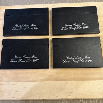 Lote de 4 juegos de monedas de plata a prueba de Estados Unidos como nuevas 1994, 1996, 1997, 1998 certificado de autenticidad Foto 1 de 4