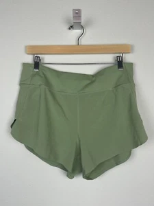 Pantaloncini corti Athleta Run With It verde oliva taglia M 3,5" cucitura interna tasca zip - Foto 1 di 8