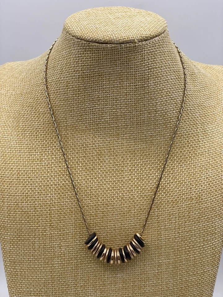 "Collar Robert Lee Morris tono dorado con discos en tonos negros y dorados firmado 19"" L" Foto 1 de 2