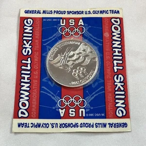 NUEVO 1998 Moneda de Coleccionista de los Juegos Olímpicos de Nagano General Mills Equipo de Esquí Descenso EE. UU. - Imagen 1 de 2