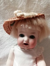 ANTIQUE DOLL with dress and straw hat