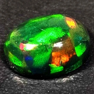 NATURAL AAA+ELEGANT COLOR PLAY OVAL CABOCHAN  ETHIOPIAN WELO BLACK OPAL 1.20 CTS - Image 1 of 3