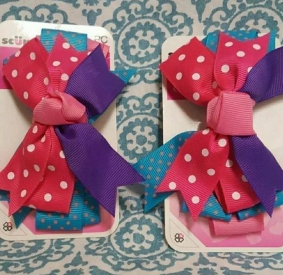 Clip de pelo Scunci Girl 2pk moño rosa azul y púrpura Foto 1 de 1