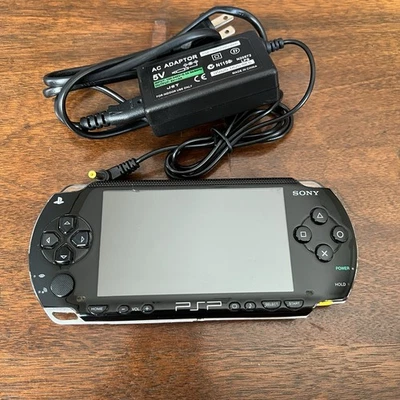 PSP 1001 + Official Sony Memory 1GB + Charger + New Battery + Tony Hawk Proj. 8 - Image 1 of 4