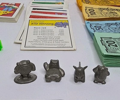 Pokemon Monopoly 1999 4 Replacement Pewter Tokens, Money, 28 DEEDS & 32 CARDS - Image 1 of 4
