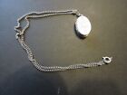 Oval locket holds two pictures silvertone with fine chain 18 inch